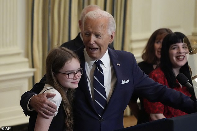 Awkward moment Joe Biden tells freed prisoner’s 12-year-old daughter ‘no serious guys until you’re 30’ as he puts an arm around her and leads ‘Happy Birthday’ chant